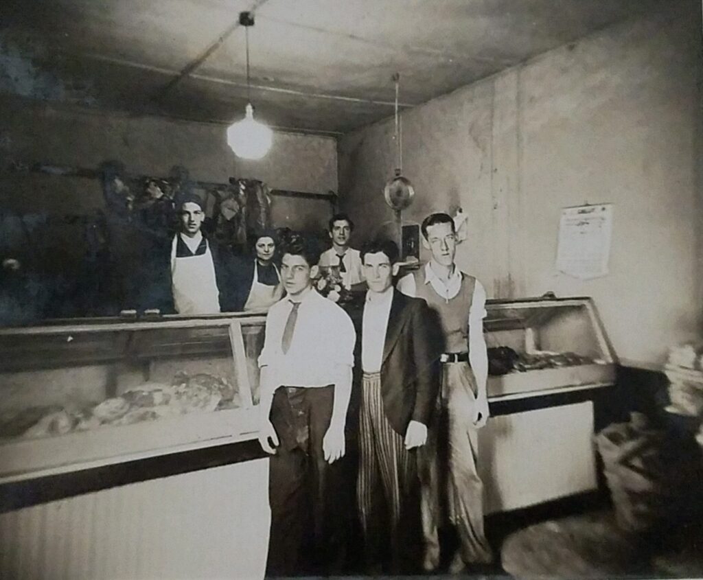 Josephine Bologna my paternal grandmother) with her brothers and a cousin. French Quarter butcher shop.